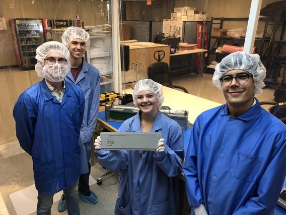 Photo of UMN’s first CubeSat and members of the student team who built it.